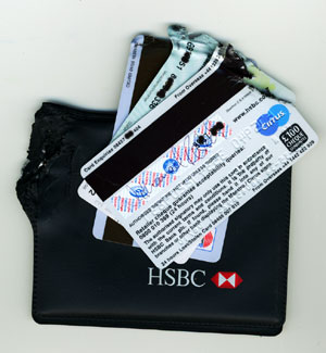Train-run-over pouch with bank & insurance cards.